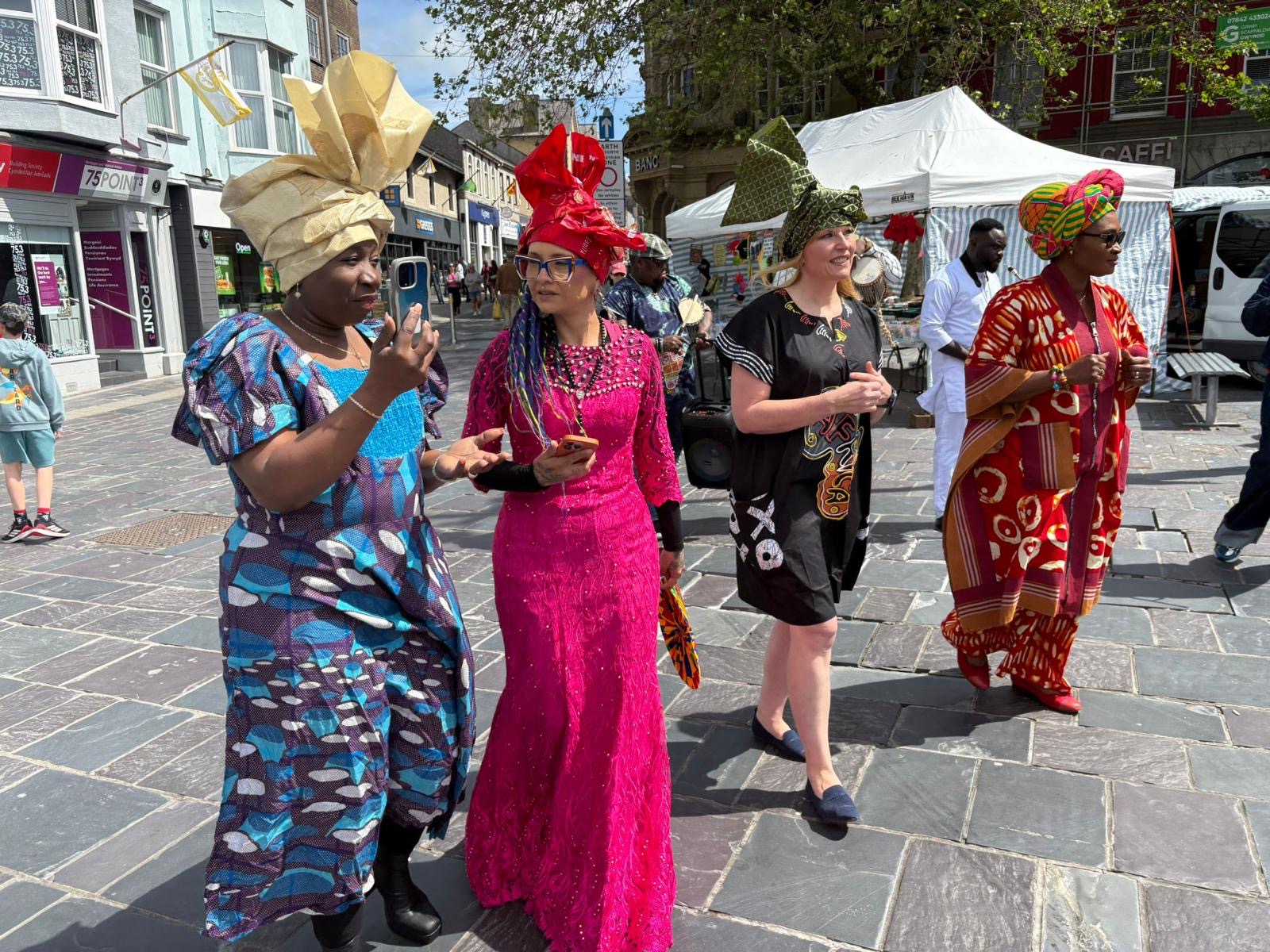 Participants in colorful clothing during a street celebration