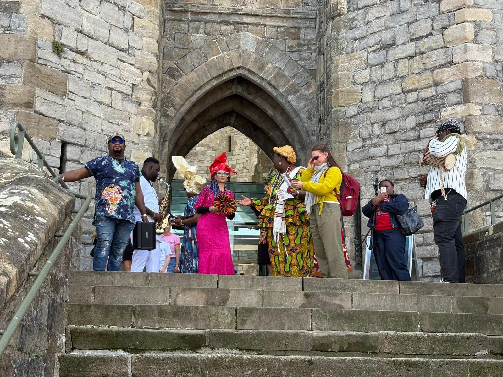 Community gathering beneath a historic stone arch