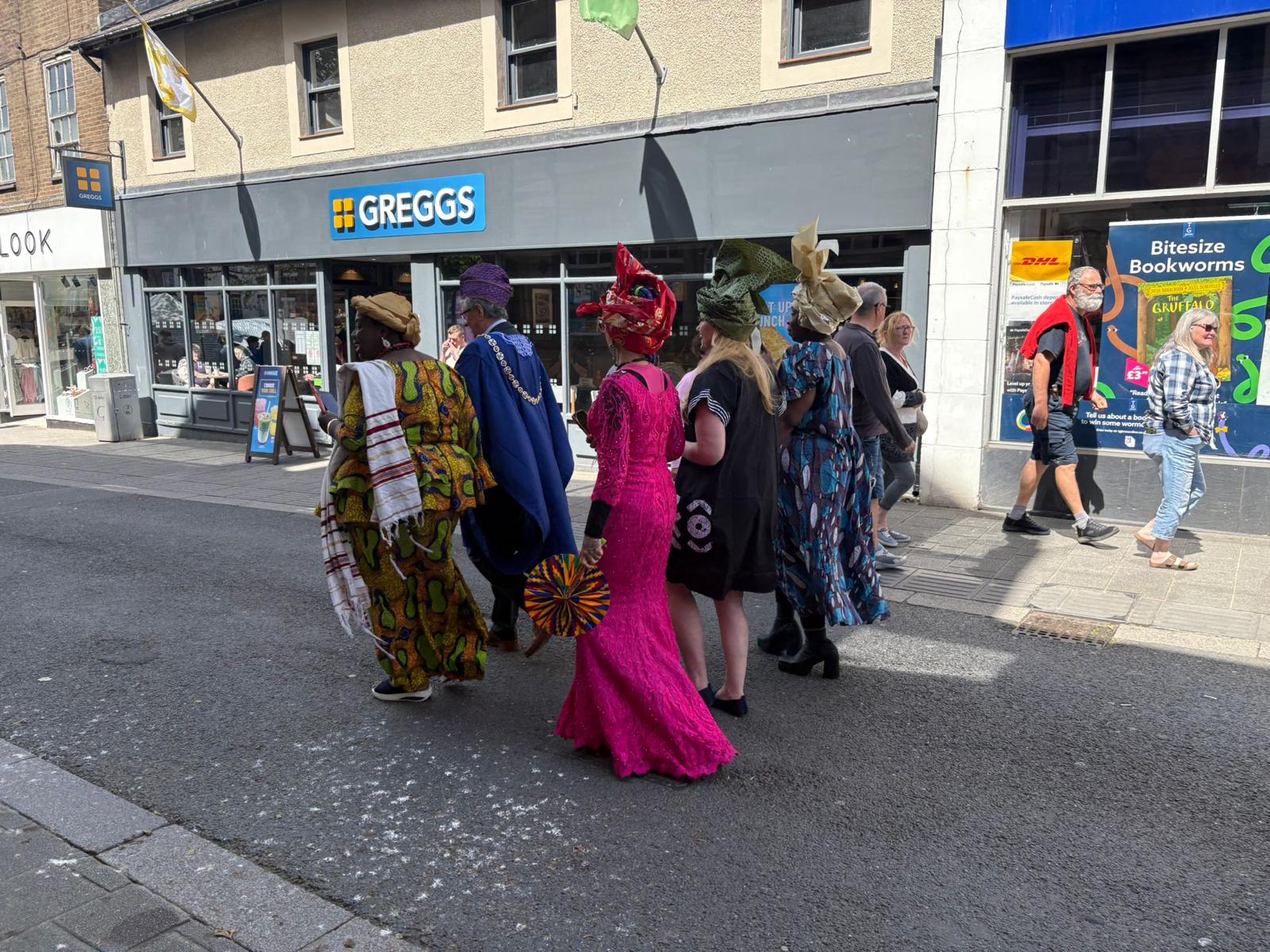Participants walking together during a street celebration